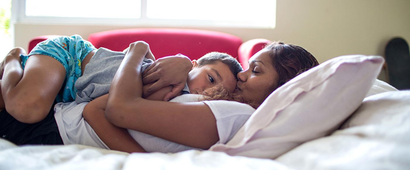 Mother comforting sick child