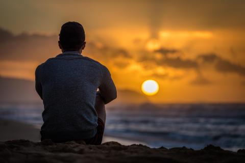 Mental health-silhouette young man on beach