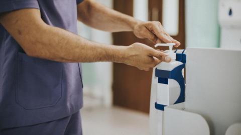 Male nurse disinfecting his hands