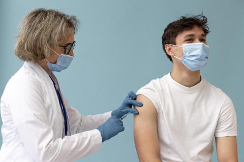 GP giving a patient a vaccine